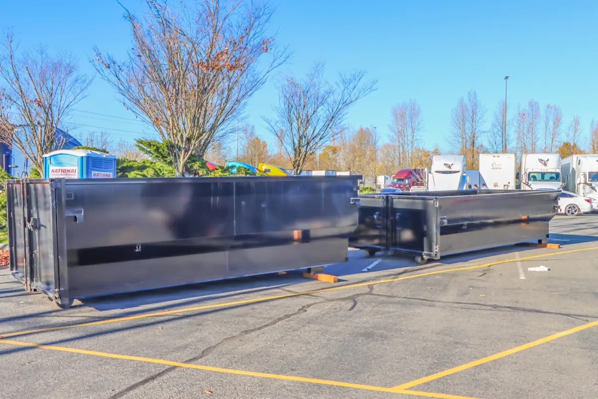 Professional dumpster rental service with roll-off container on residential driveway in Paulsboro